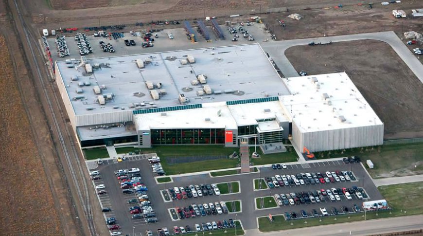 Aerial view of Bobcat Acceleration Building with parking lot to the bottom, building in center, and lot to the background.