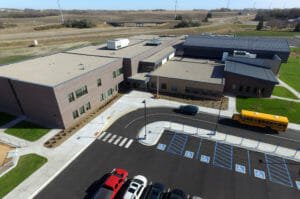 Aerial drone view of Rothsay Public School entrance and newly paved and striped parking lot.