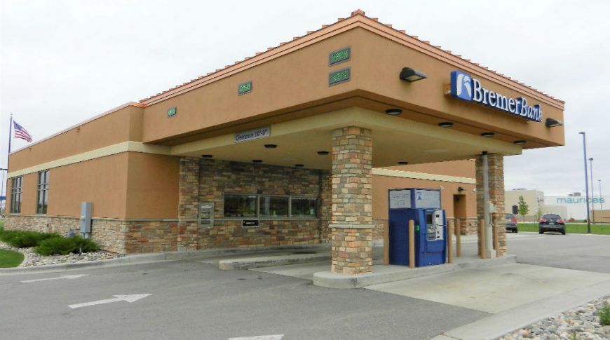 Outside concrete and stone awning covering bank teller drive-ups stations.