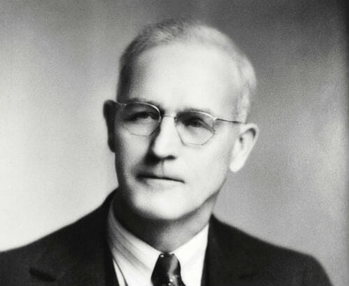 Black and white headshot photo of Clark Morrell Comstock who founded Comstock Construction in 1924