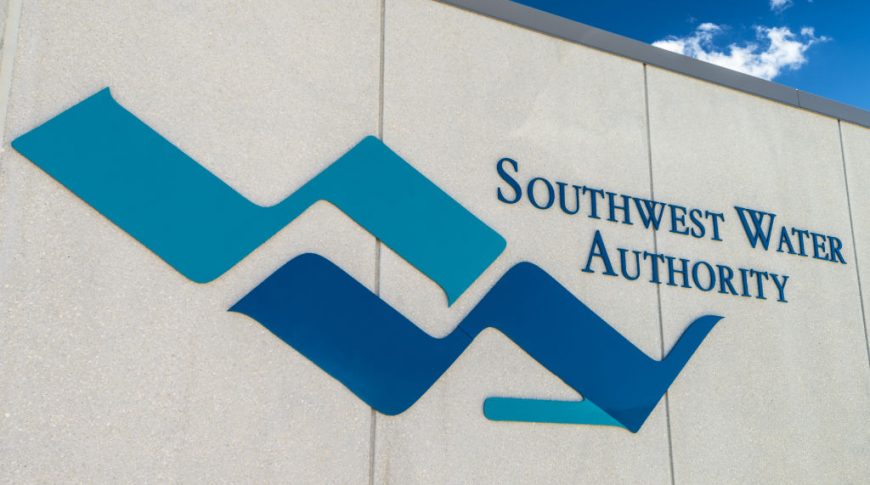 Exterior stucco beige wall with Southwest Water Authority blue logo