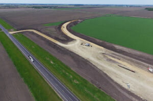 Aerial view of sitework for a new grain handling facility and rail loop track.