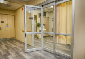Hallway outside Prep and Recovery Patient Room showing off the three paned glass retractable doors.