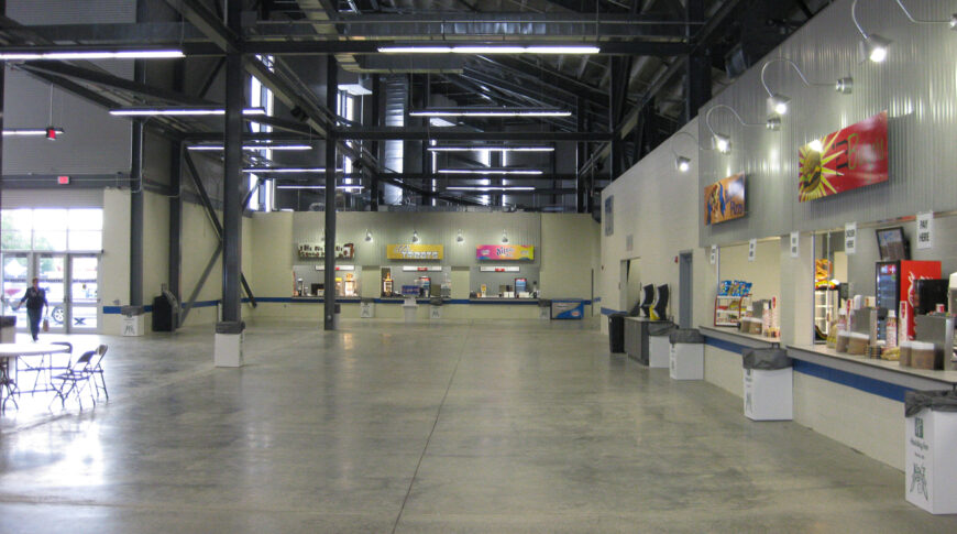 Concession stand covered area underneath North Dakota State Fair Grandstands with concrete floors and metal roof.