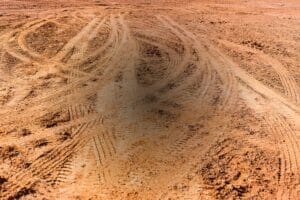 Tire tracks in a dried dirt field