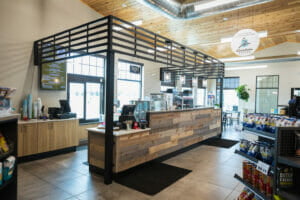 Caribou Coffee store with black metal frame and rustic shiplap counter in a Cenex C-Store.