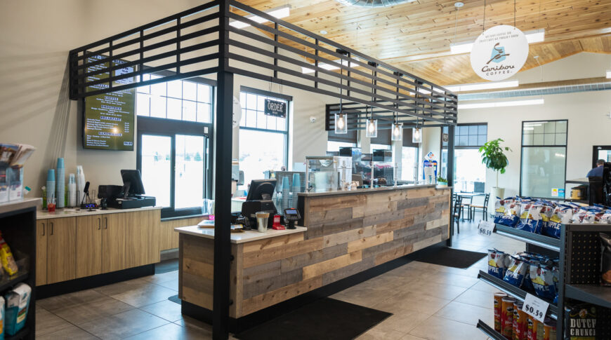 Caribou Coffee store with black metal frame and rustic shiplap counter in a Cenex C-Store.